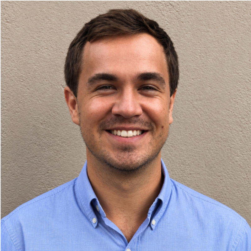 Hugo Van der Merwe, smiling in a blue shirt
